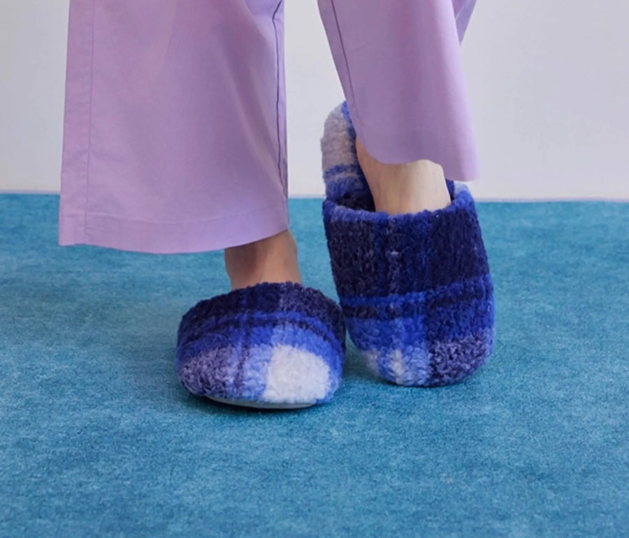 Blue Farfary slippers styled on a textured rug